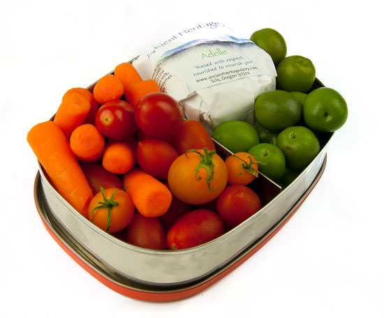Fresh vegetables, olives and cheese in a metal container