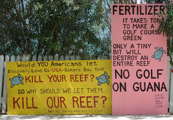 Guana Signs. One says: Fertilizer, it take tons to make a golf course green. Only a tiny bit will destroy an entire reef. NO GOLF ON GUANA.