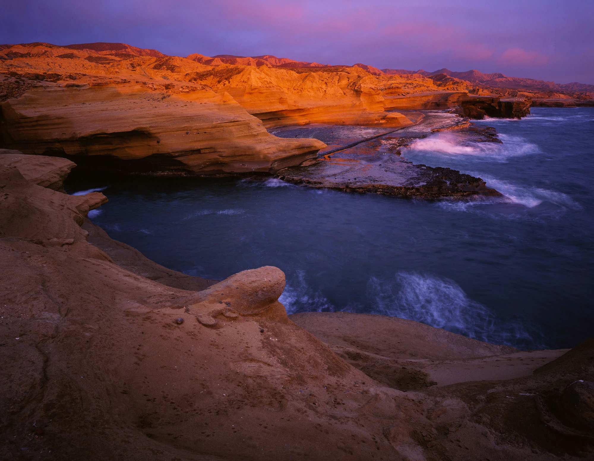 Dramatic cliffs along the Pacific Ocean in Baja California Norte, where rugged desert mountains meet the sea