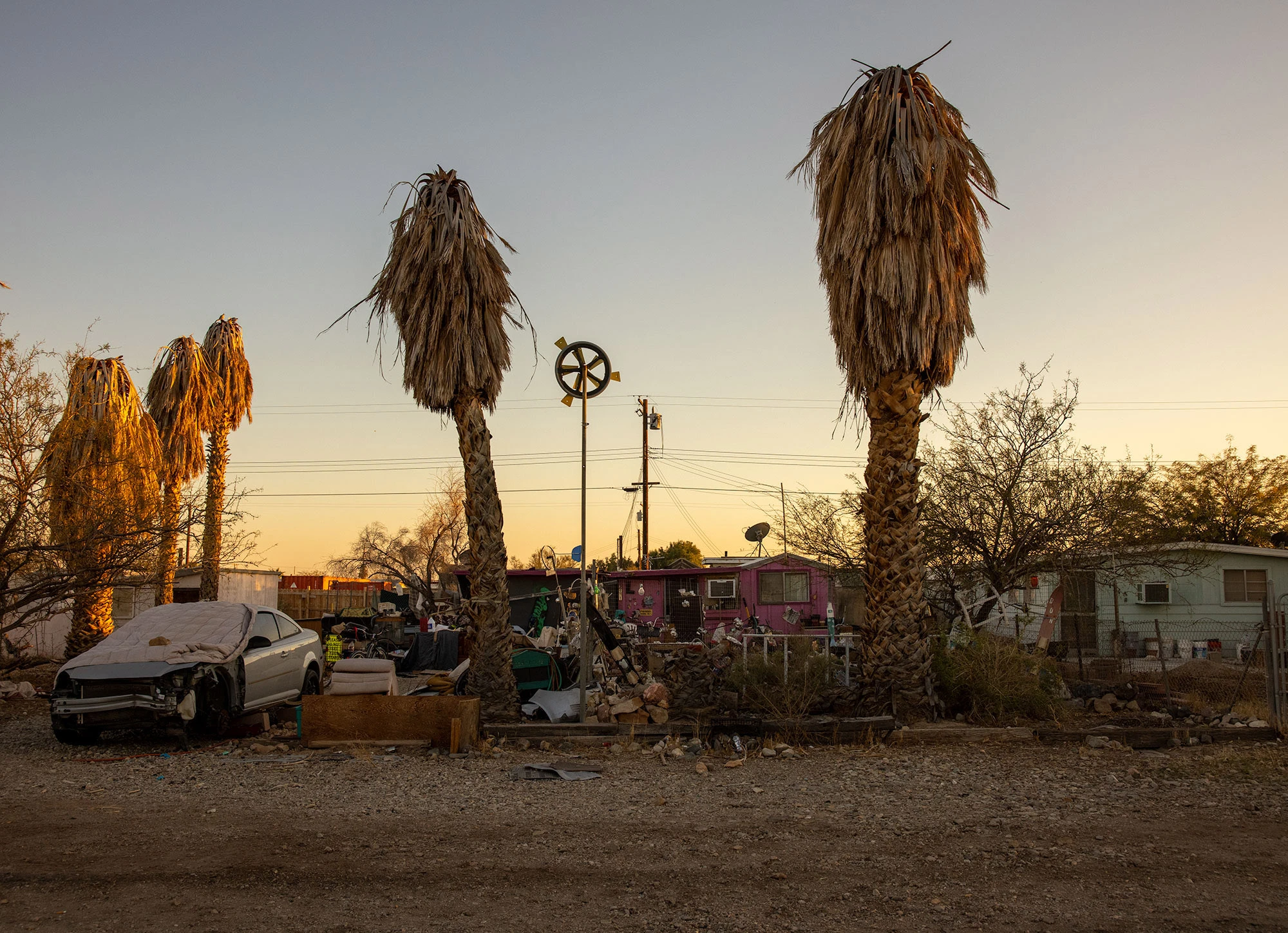 Weathered signs at the entrance to Bombay Beach, California, their faded paint and rusted metal evoking the quirky resilience and surreal atmosphere of this Salton Sea community on the edge of decay.