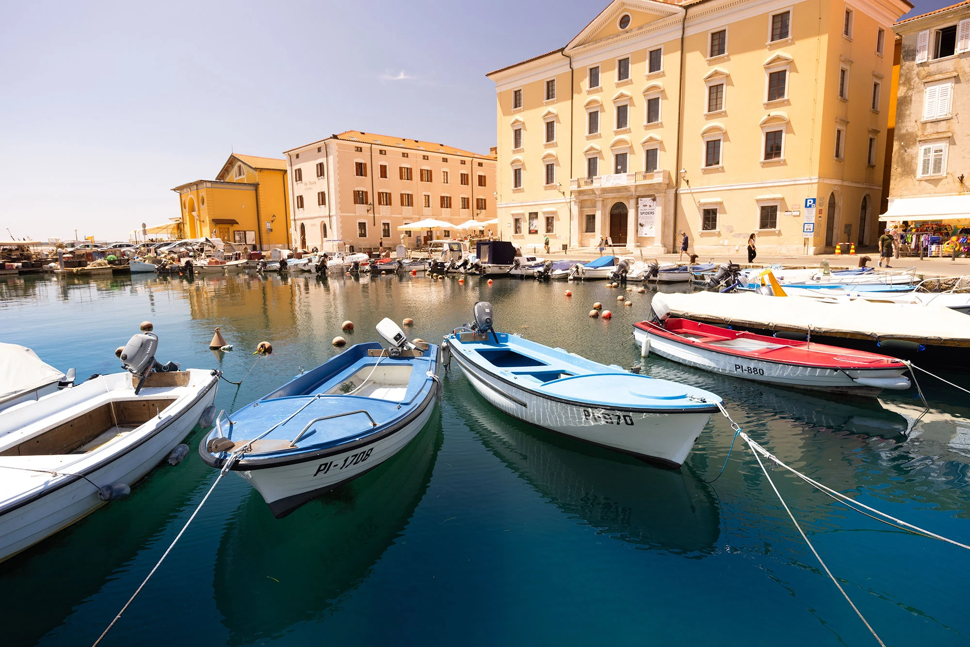 Small fishing boats rest in the harbor of Piran, Slovenia.